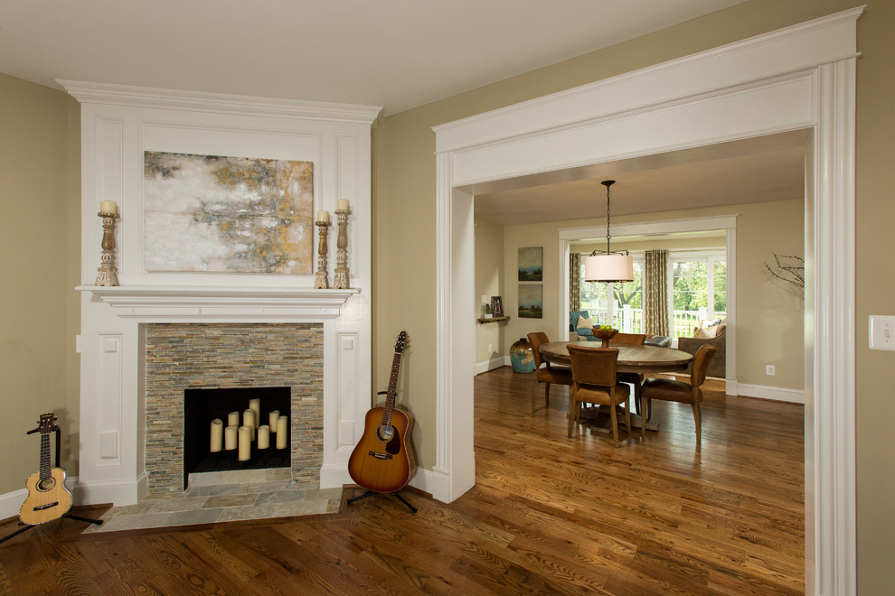 Example of an ornate open concept medium tone wood floor living room design in DC Metro with beige walls, a corner fireplace and a stone fireplace