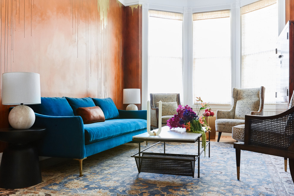 На фото: парадная, изолированная гостиная комната среднего размера в стиле фьюжн с оранжевыми стенами и паркетным полом среднего тона без камина, телевизора с