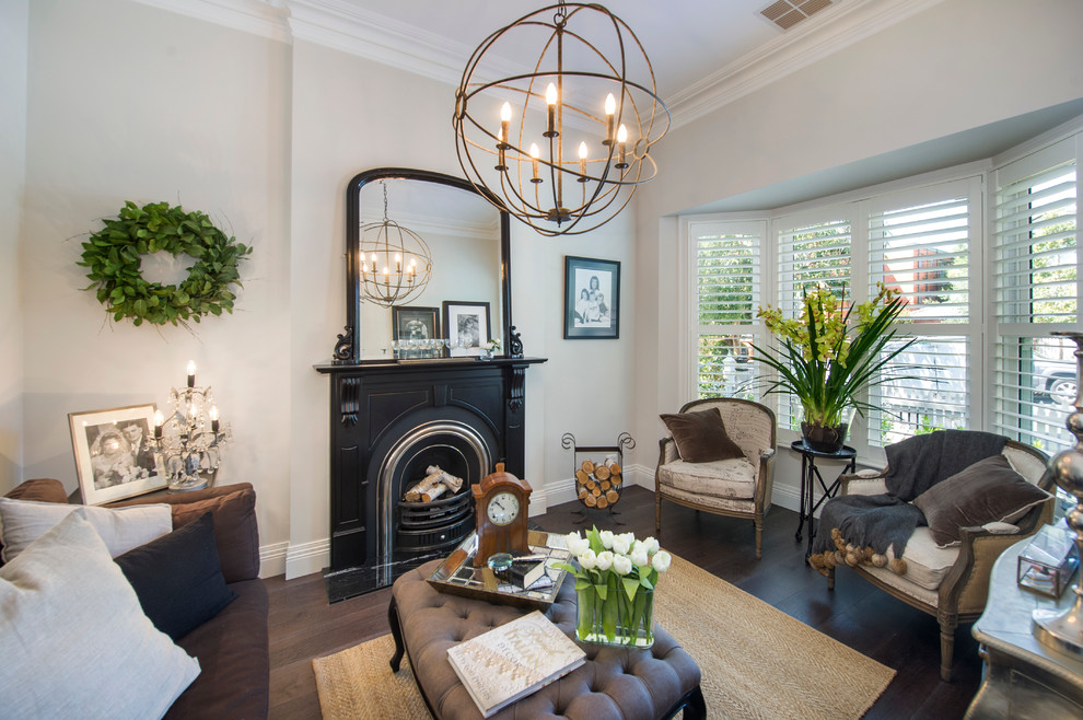 Photo of a small victorian formal enclosed living room in Melbourne with white walls, medium hardwood flooring, a standard fireplace and a metal fireplace surround.
