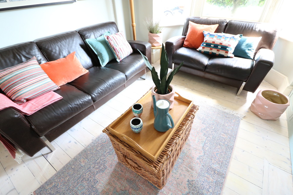 Mid-sized eclectic light wood floor living room photo in Cambridgeshire with blue walls