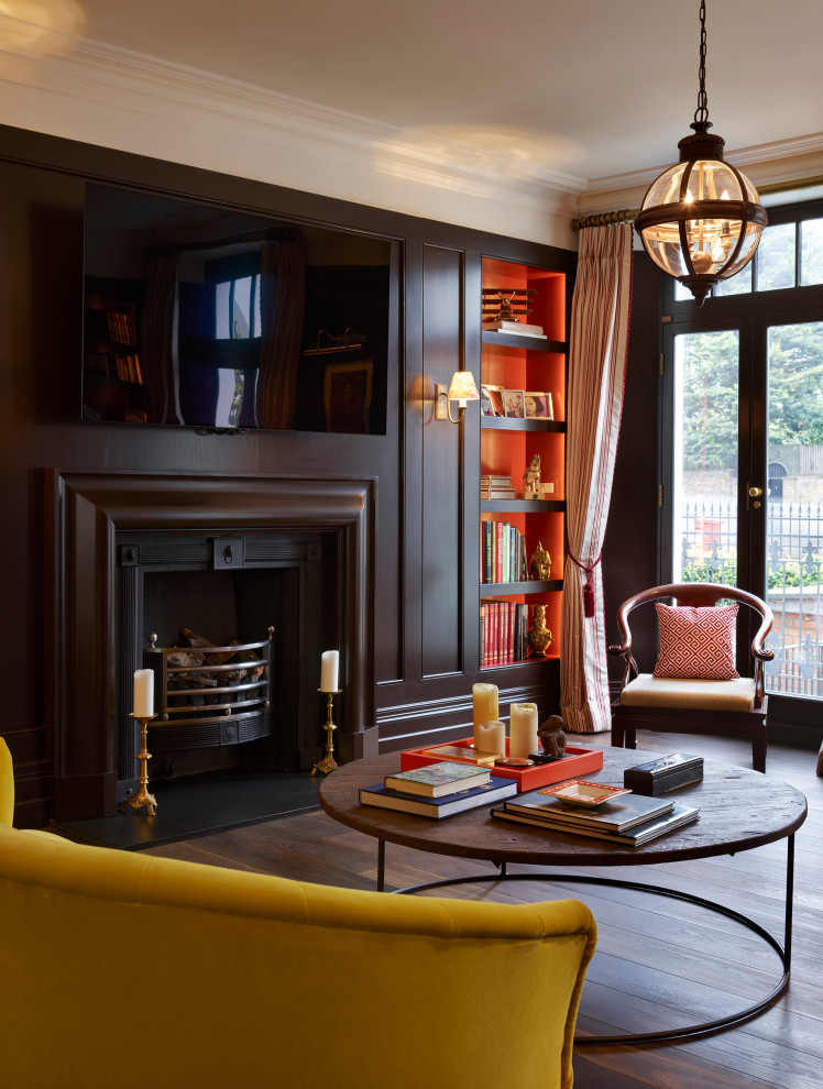 Photo of a large victorian formal open plan living room in London with brown walls, medium hardwood flooring, a standard fireplace, a wooden fireplace surround, a wall mounted tv and brown floors.