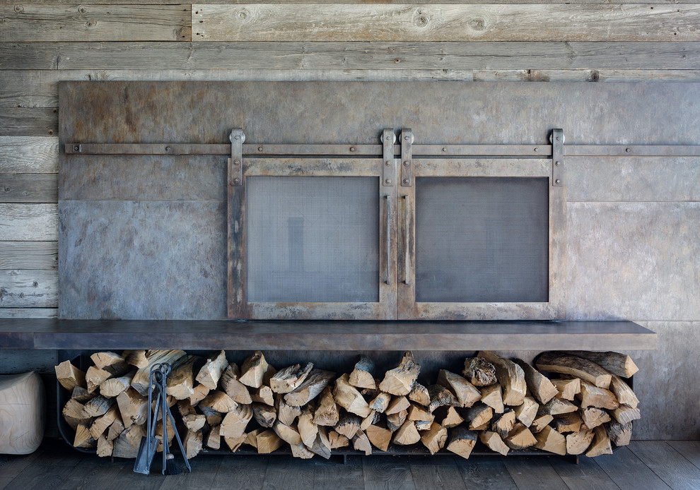 This is an example of a rustic living room in Philadelphia with a metal fireplace surround.