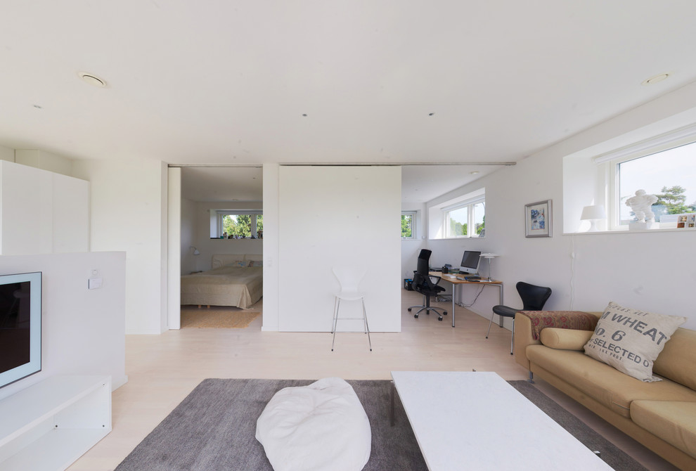 Exempel på ett mellanstort skandinaviskt separat vardagsrum, med ett finrum, vita väggar, ljust trägolv och en väggmonterad TV