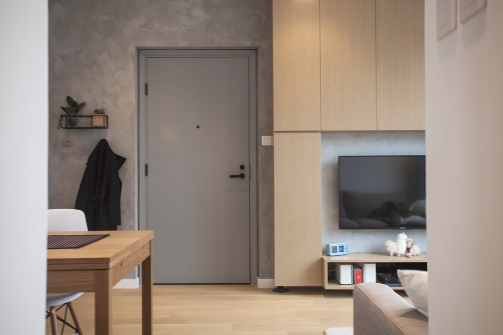 Photo of a medium sized modern enclosed living room in Hong Kong with grey walls, medium hardwood flooring and a wall mounted tv.