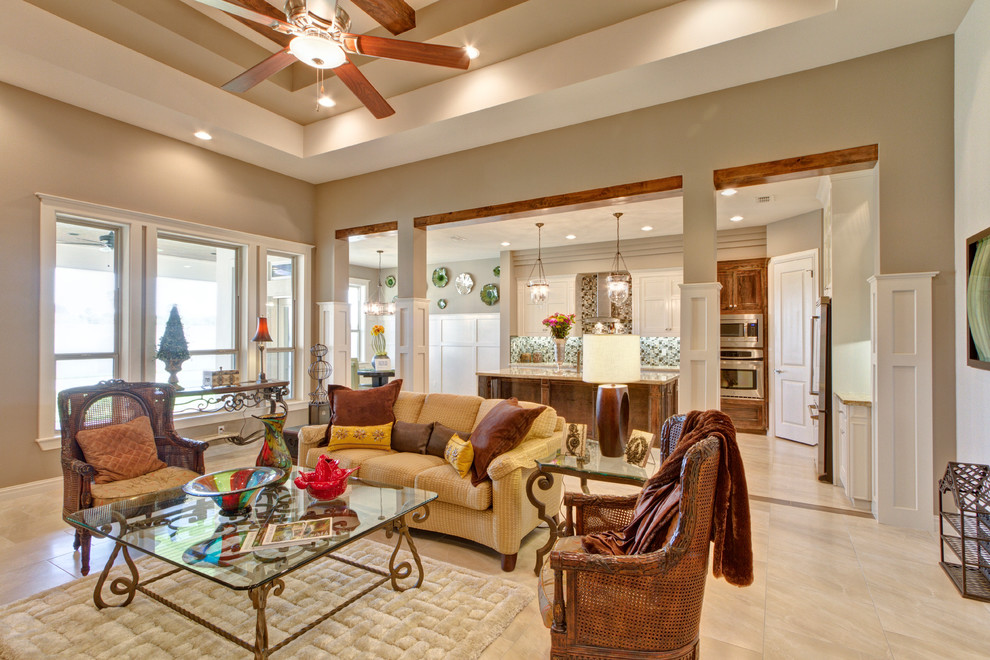 Example of a large mountain style open concept ceramic tile and beige floor living room design in Austin with beige walls and no fireplace