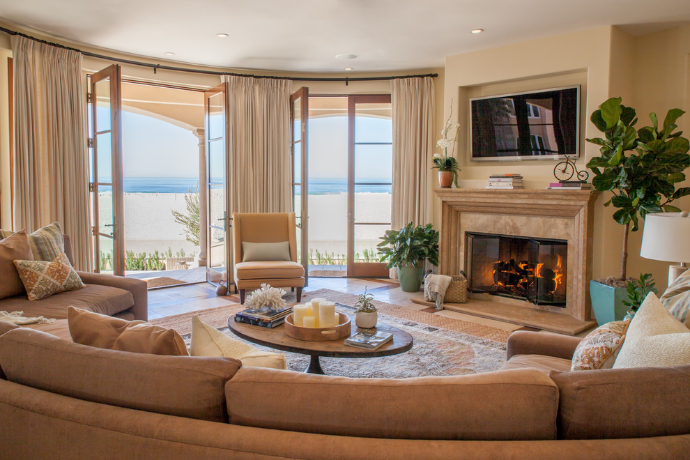 Inspiration for a large mediterranean formal open plan living room in Los Angeles with beige walls, a standard fireplace, a stone fireplace surround and a wall mounted tv.
