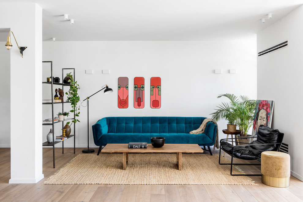 Photo of a scandinavian living room in Tel Aviv with white walls, medium hardwood flooring and brown floors.