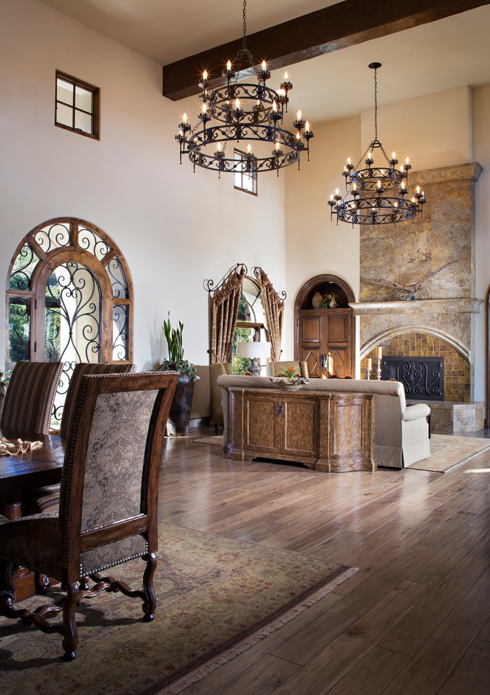 Large tuscan formal and open concept medium tone wood floor living room photo in San Diego with beige walls, a standard fireplace and a stone fireplace