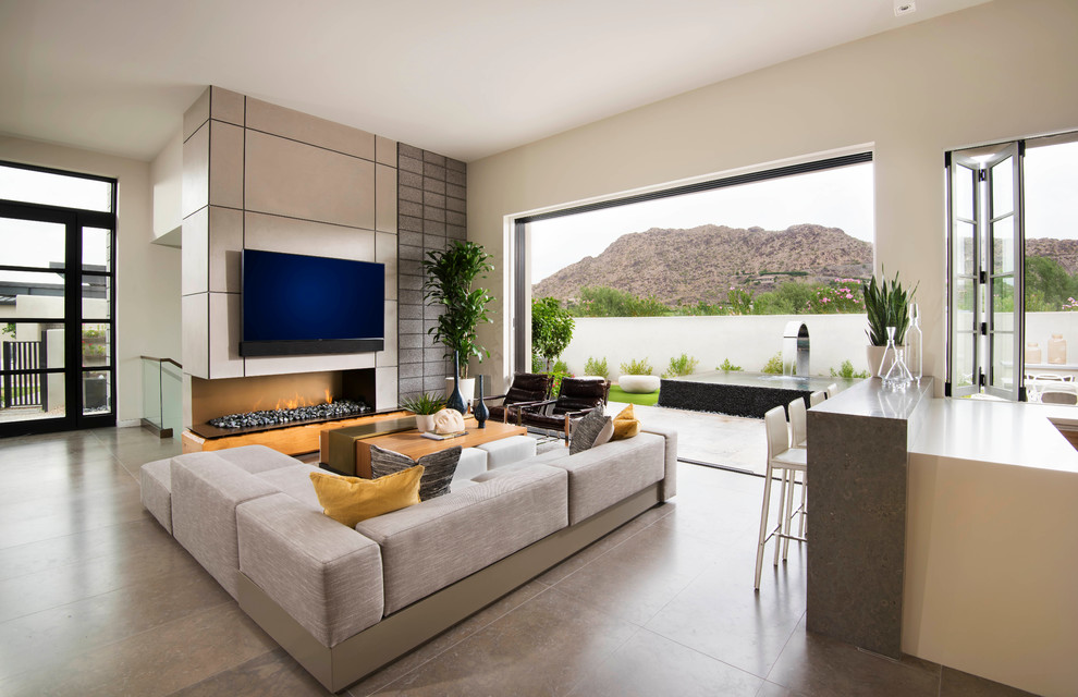 Photo of a contemporary open plan living room in Phoenix with limestone flooring and a wall mounted tv.