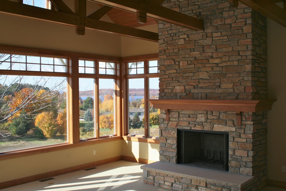 Inspiration for a mid-sized craftsman open concept living room remodel in Other with beige walls, a standard fireplace and a stone fireplace