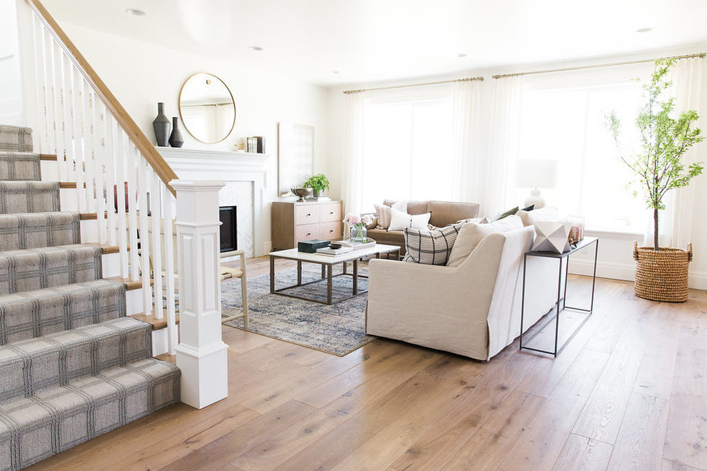 Inspiration for a transitional open concept medium tone wood floor living room remodel in Salt Lake City with white walls and a standard fireplace