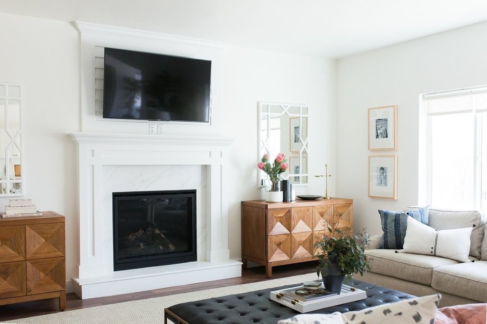 Inspiration for a mid-sized transitional open concept medium tone wood floor living room remodel in Salt Lake City with white walls and a standard fireplace