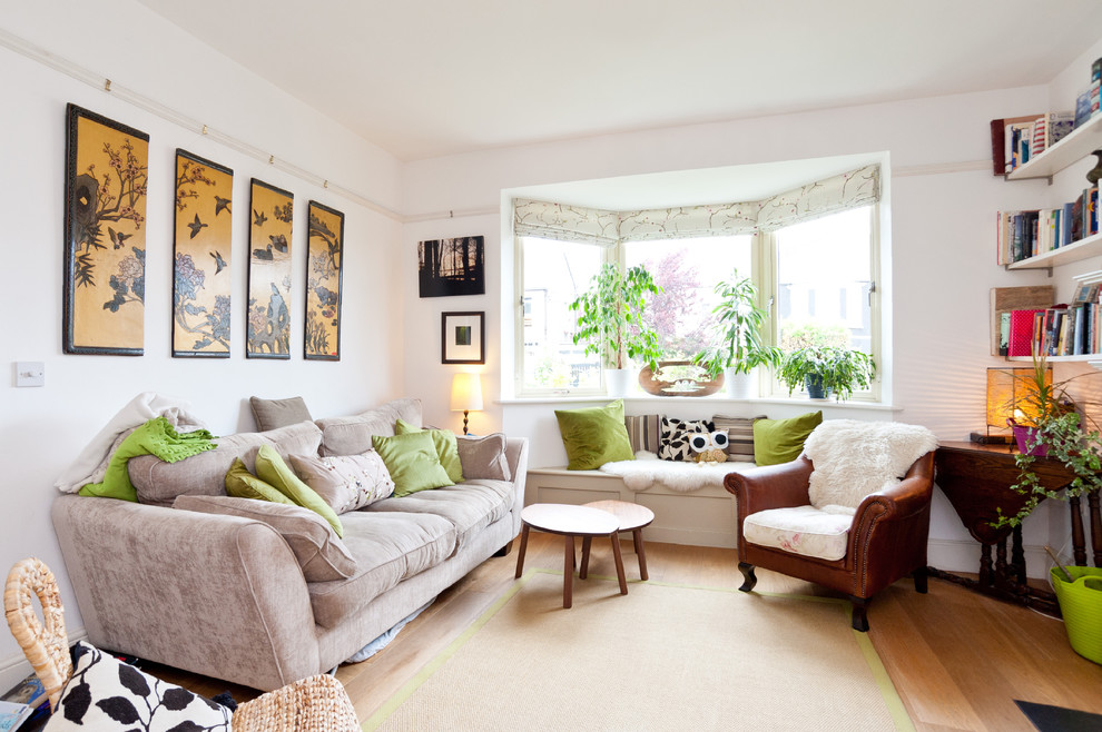 Photo of a medium sized bohemian enclosed living room in Dublin with white walls.