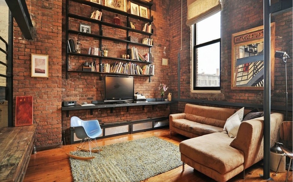 Großes, Offenes Industrial Wohnzimmer mit braunem Holzboden und freistehendem TV in Sonstige