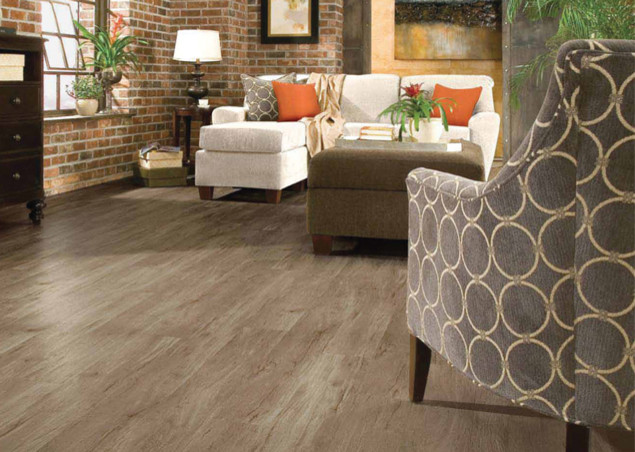 This is an example of an industrial living room in Oklahoma City with vinyl flooring and brown floors.