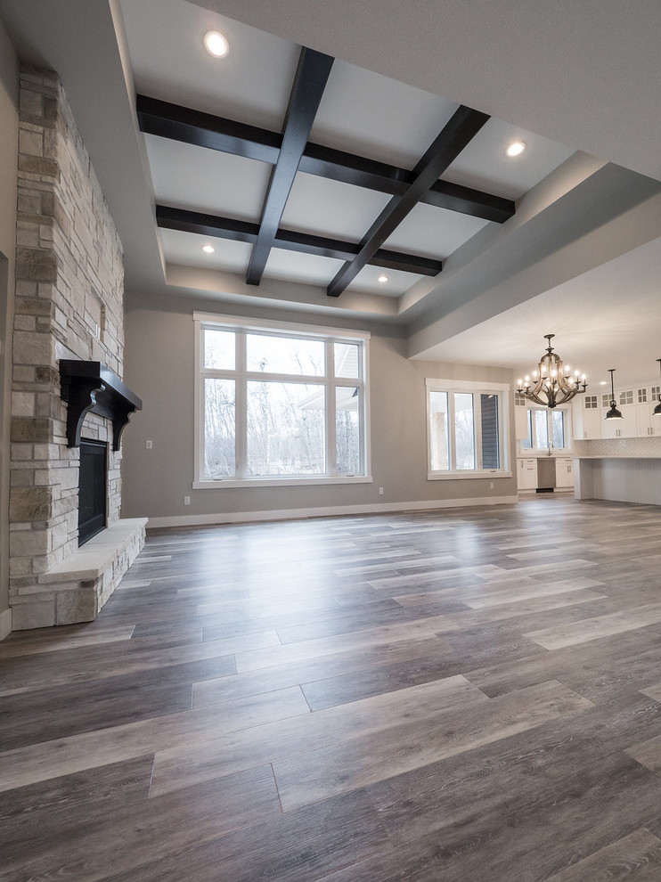 Design ideas for a large modern formal open plan living room in Edmonton with vinyl flooring, a standard fireplace, a brick fireplace surround and multi-coloured floors.
