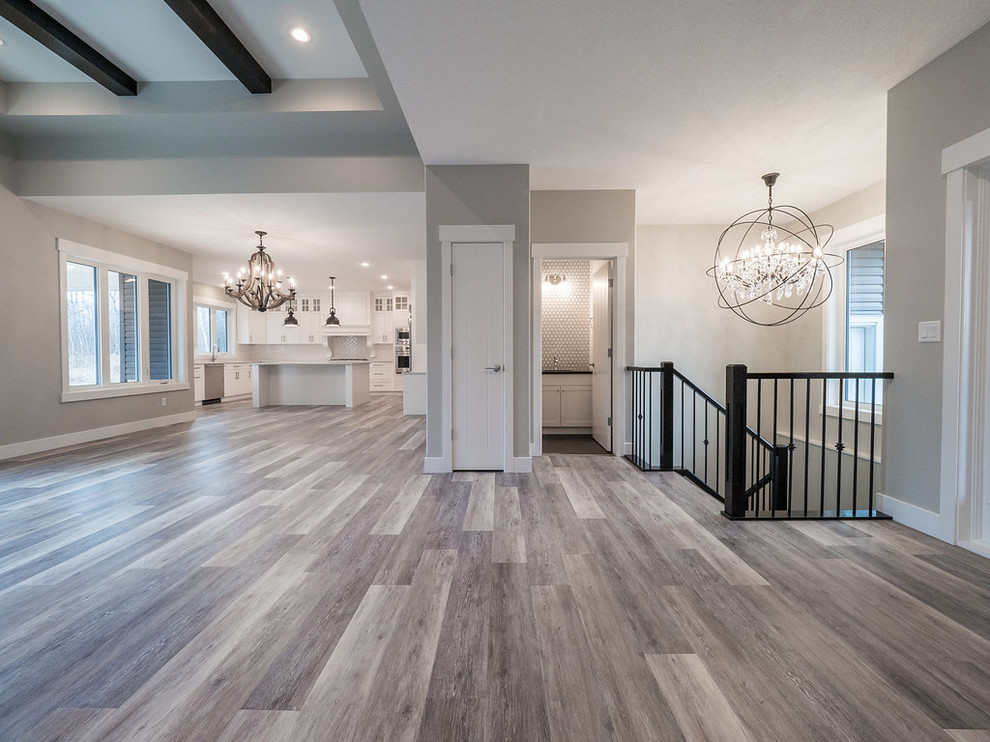 Example of a large minimalist formal and open concept vinyl floor and multicolored floor living room design in Edmonton with a standard fireplace and a brick fireplace