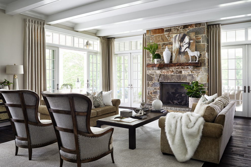 French country dark wood floor, brown floor and exposed beam living room photo in Other with beige walls, a standard fireplace and a stone fireplace