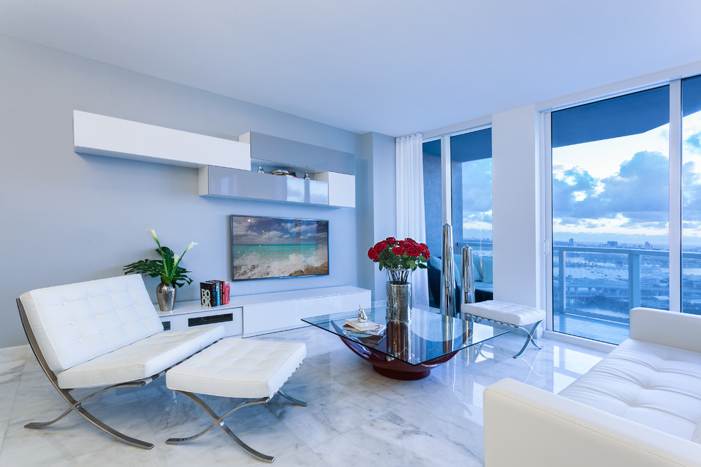 Immagine di un soggiorno minimal di medie dimensioni e aperto con pavimento in marmo, nessun camino e TV a parete