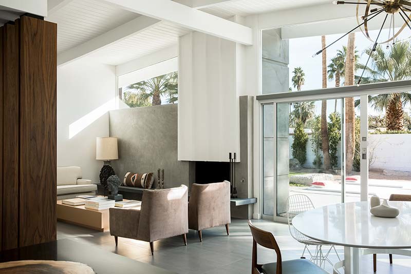 Living room - mid-sized mid-century modern open concept porcelain tile living room idea in Los Angeles with white walls, a standard fireplace, a concrete fireplace and no tv