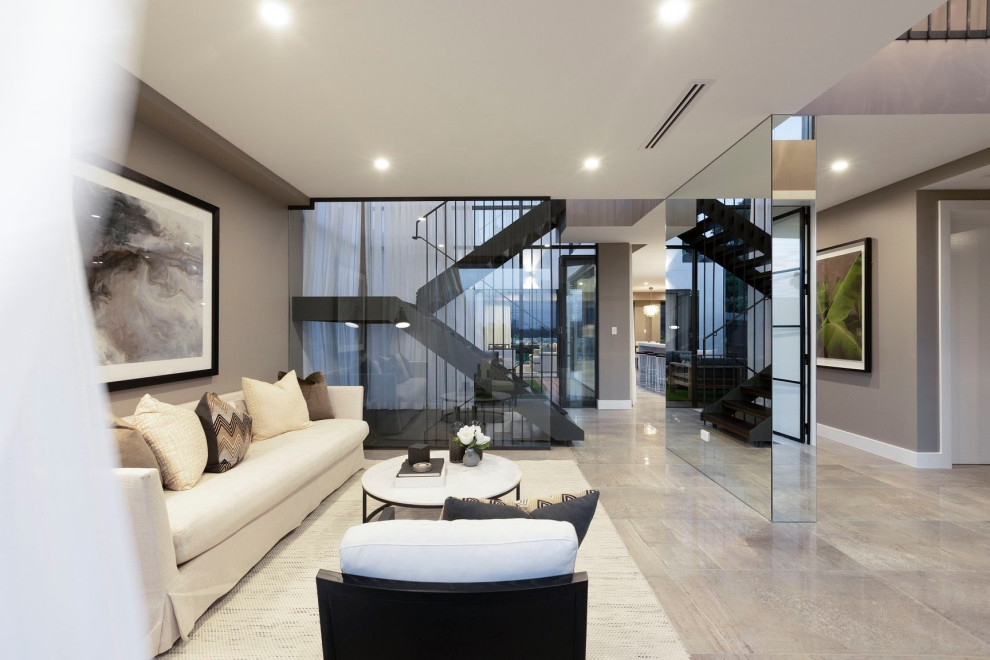 This is an example of a contemporary formal open plan living room in Sydney with grey walls, no fireplace, no tv and multi-coloured floors.