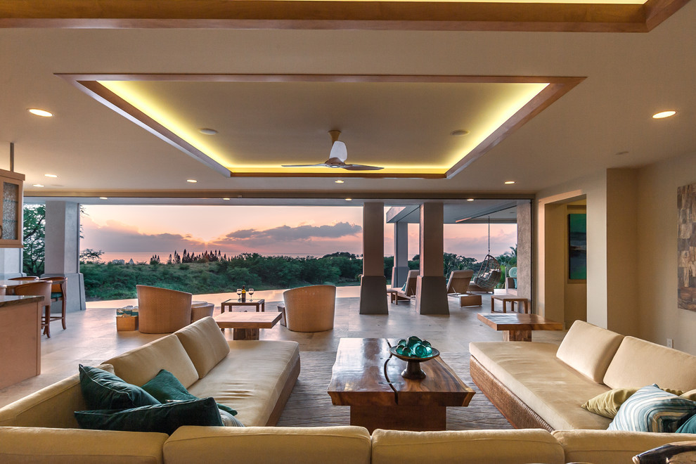 Großes, Offenes, Repräsentatives Wohnzimmer ohne Kamin mit beiger Wandfarbe, Travertin, verstecktem TV und beigem Boden in Hawaii