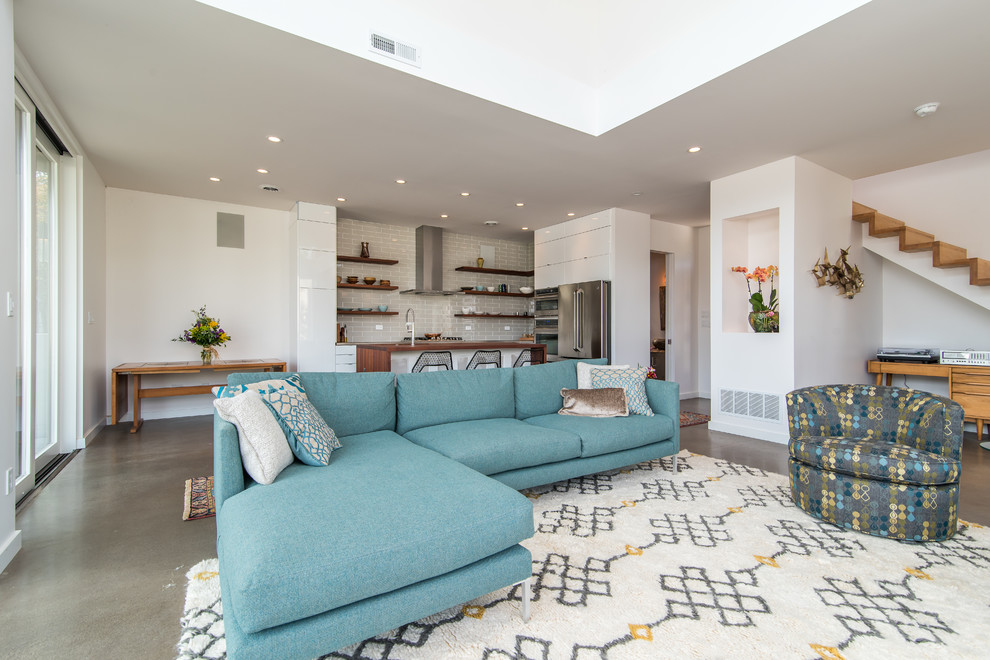 Свежая идея для дизайна: маленькая гостиная комната в стиле модернизм с белыми стенами, бетонным полом, скрытым телевизором и серым полом для на участке и в саду - отличное фото интерьера