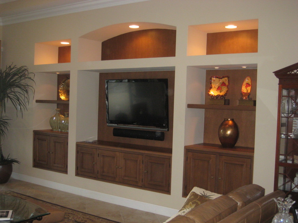 Living room - large traditional formal and enclosed ceramic tile living room idea in Miami with a wall-mounted tv, beige walls and no fireplace