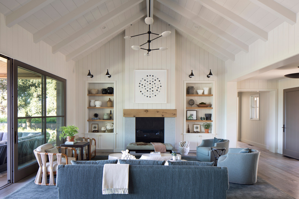 Inspiration for a rural open plan living room in San Francisco with white walls, dark hardwood flooring, a standard fireplace, brown floors, a vaulted ceiling and tongue and groove walls.