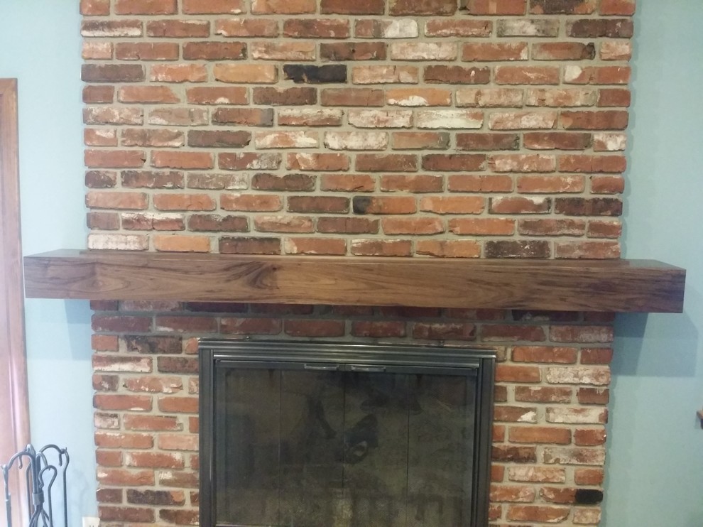 Inspiration for a small rustic open concept living room remodel in Kansas City with blue walls, a standard fireplace and a brick fireplace