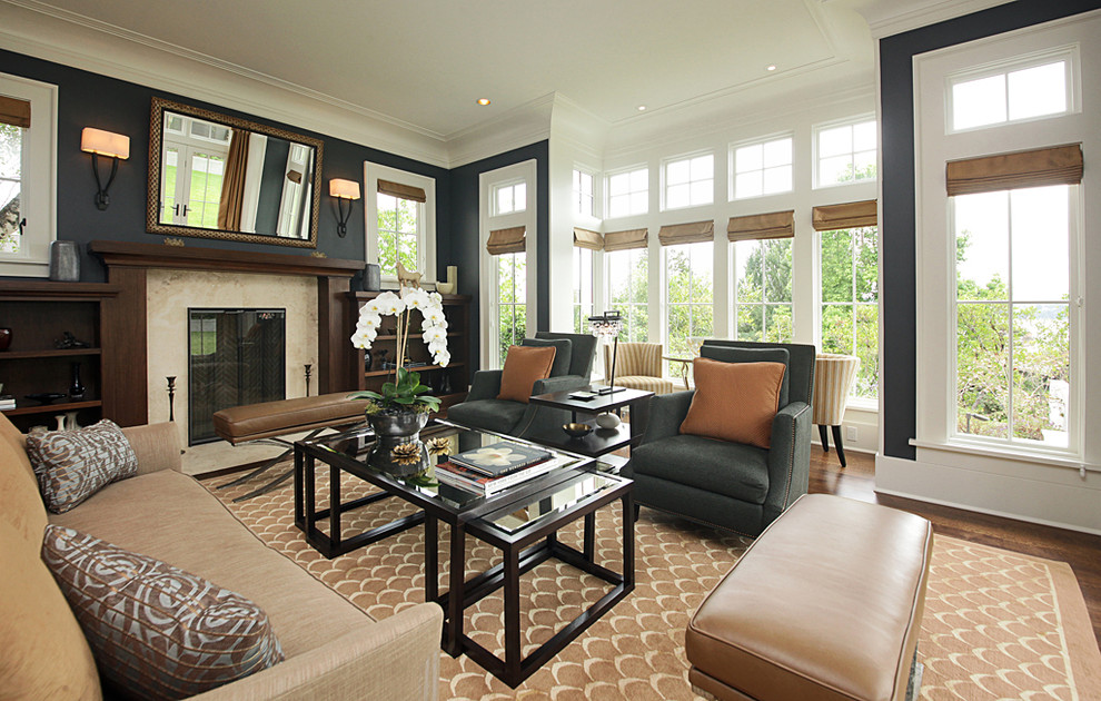 Photo of a large contemporary living room in Seattle with black walls and a standard fireplace.