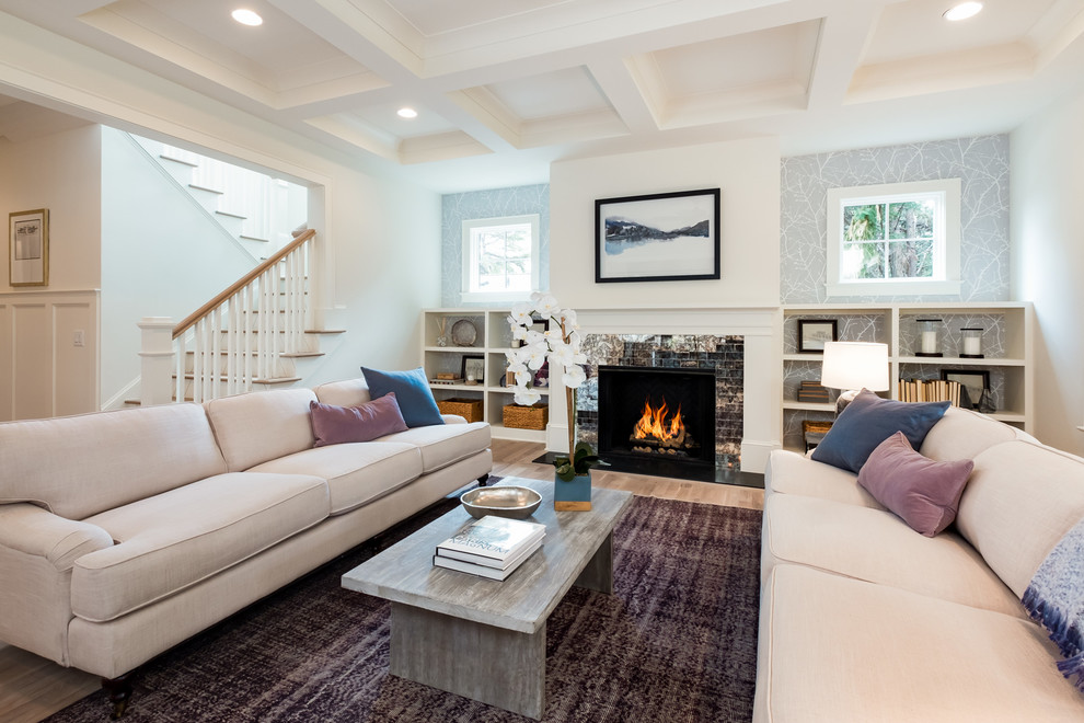 This is an example of a traditional living room in Charlotte with grey walls, a standard fireplace and no tv.