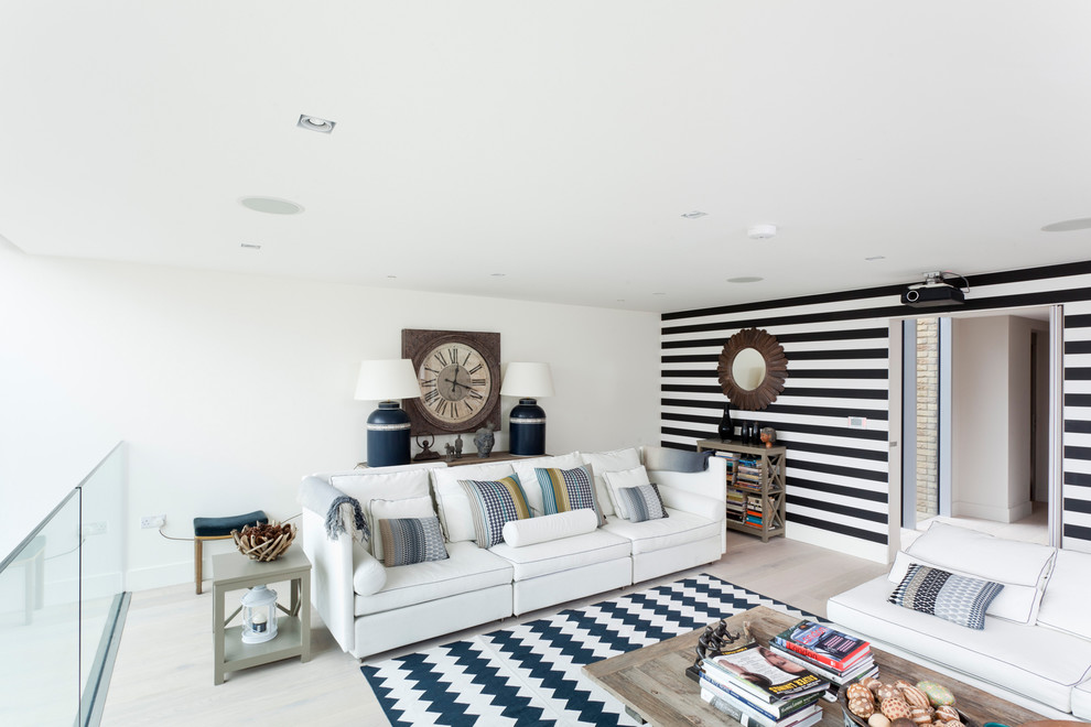 Danish loft-style light wood floor living room photo in Orange County with white walls