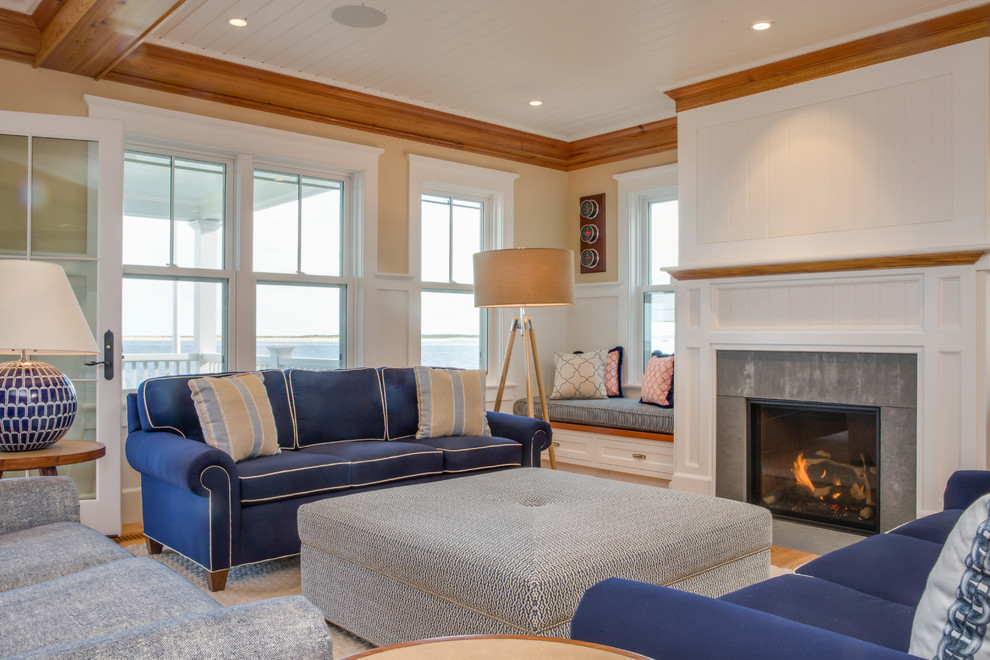 Inspiration for a large beach style formal open plan living room in Boston with beige walls, medium hardwood flooring, a standard fireplace, a stone fireplace surround, no tv and beige floors.