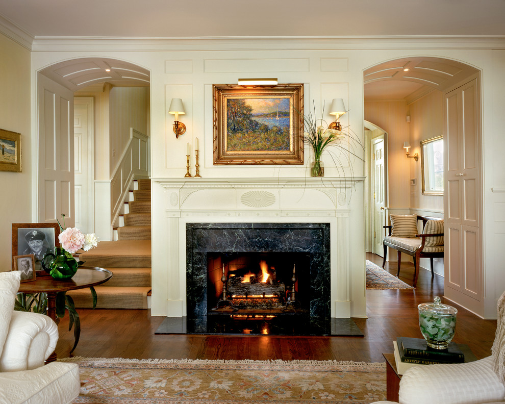 Large elegant formal and enclosed dark wood floor living room photo in New York with white walls, a standard fireplace and a plaster fireplace