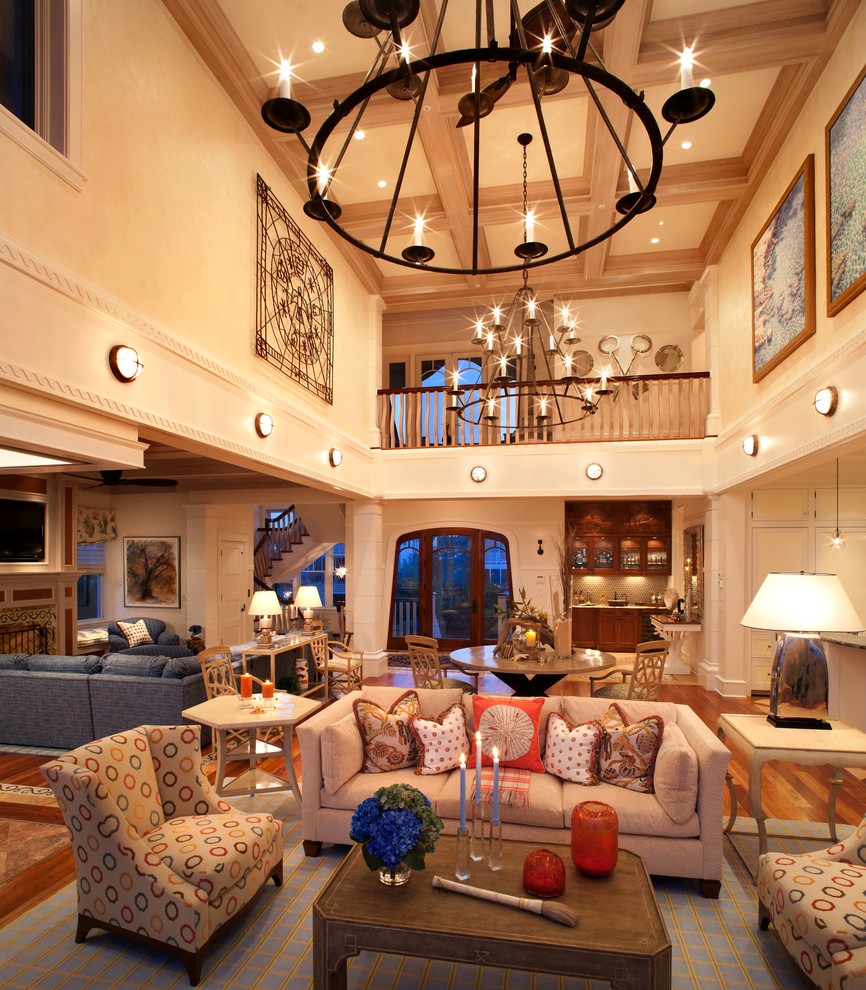 Foto de salón abierto costero extra grande sin televisor con paredes beige y suelo de madera en tonos medios