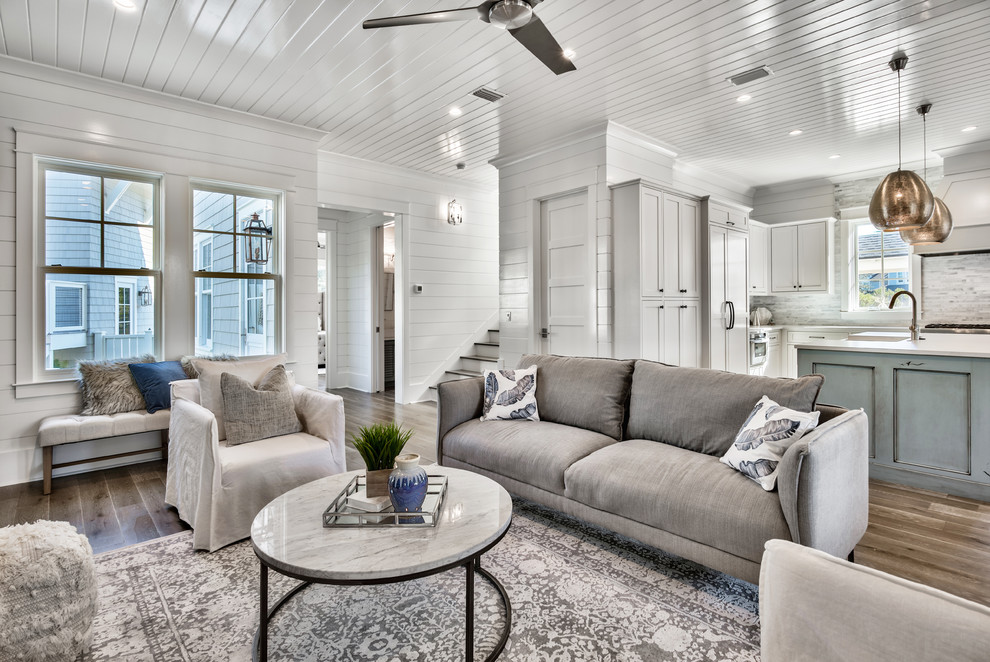 Inspiration for a medium sized coastal formal open plan living room in Miami with white walls, medium hardwood flooring, no fireplace, no tv and brown floors.