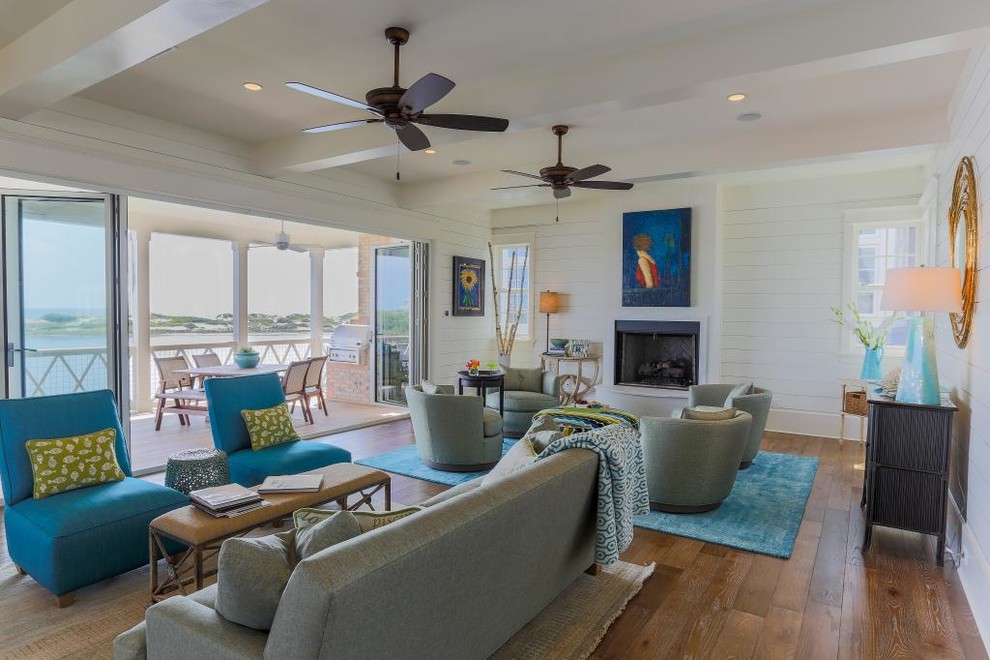 This is an example of a medium sized beach style formal open plan living room in Miami with white walls, dark hardwood flooring, a standard fireplace, a stone fireplace surround and no tv.