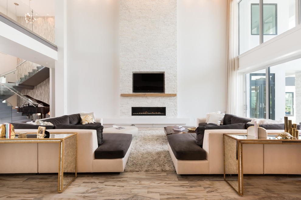 Expansive contemporary formal open plan living room feature wall in Orlando with a ribbon fireplace, a stone fireplace surround and a built-in media unit.