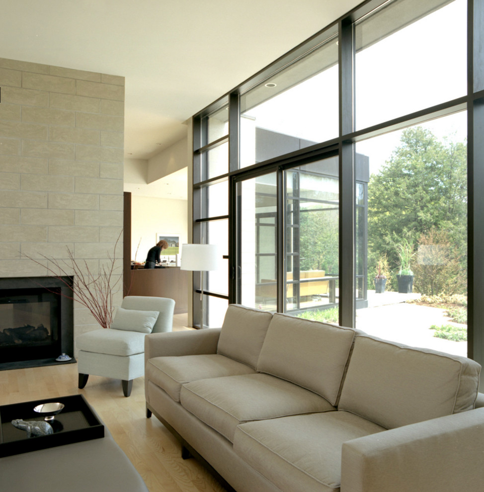Example of a mid-sized trendy enclosed and formal light wood floor and beige floor living room design in Los Angeles with white walls, a standard fireplace, a tile fireplace and no tv