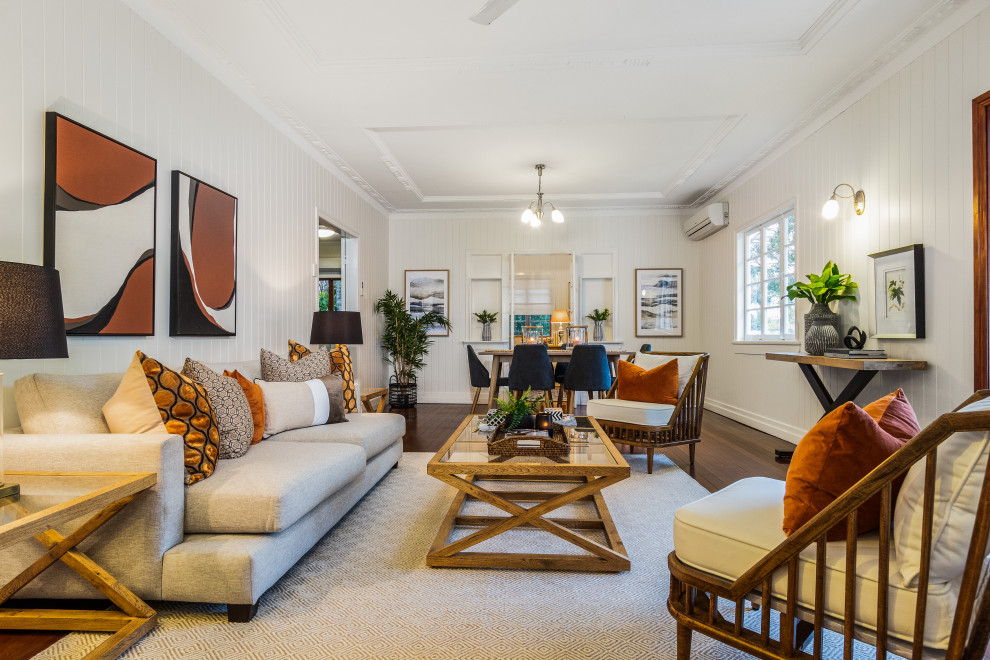 Example of a transitional enclosed dark wood floor, brown floor, tray ceiling and shiplap wall living room design in Brisbane with white walls