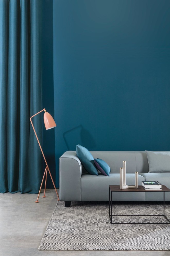 Idee per un soggiorno moderno di medie dimensioni e stile loft con pareti blu, pavimento in cemento e pavimento grigio