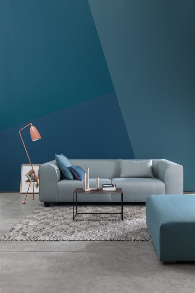 Foto di un soggiorno moderno di medie dimensioni e aperto con pareti blu, pavimento in cemento e pavimento grigio
