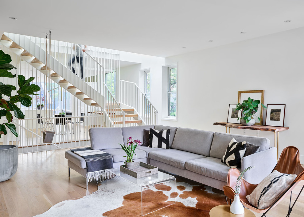 Inspiration for a contemporary open concept light wood floor living room remodel in Chicago with white walls, no fireplace and no tv