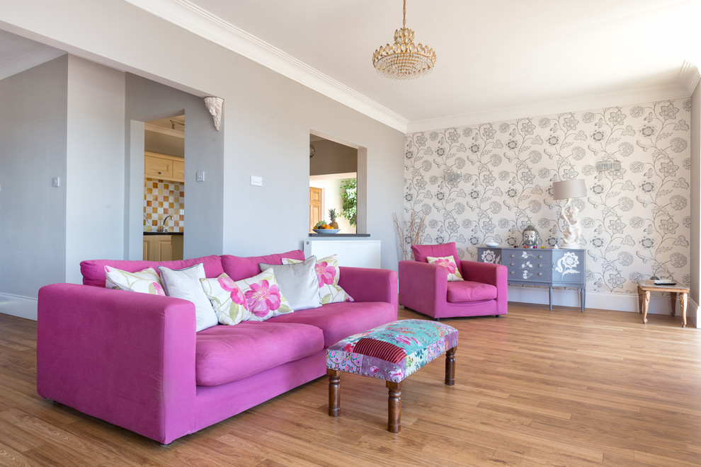 This is an example of a medium sized contemporary open plan living room in Devon with grey walls, medium hardwood flooring and a wall mounted tv.
