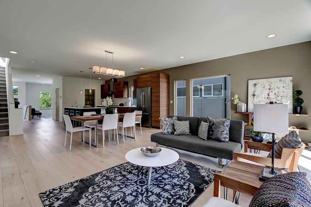 Photo of a contemporary open plan living room in Seattle with light hardwood flooring and brown walls.