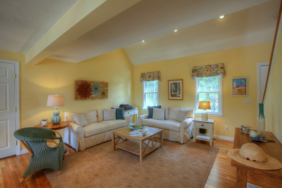 Expansive coastal open plan living room in Boston with yellow walls and medium hardwood flooring.