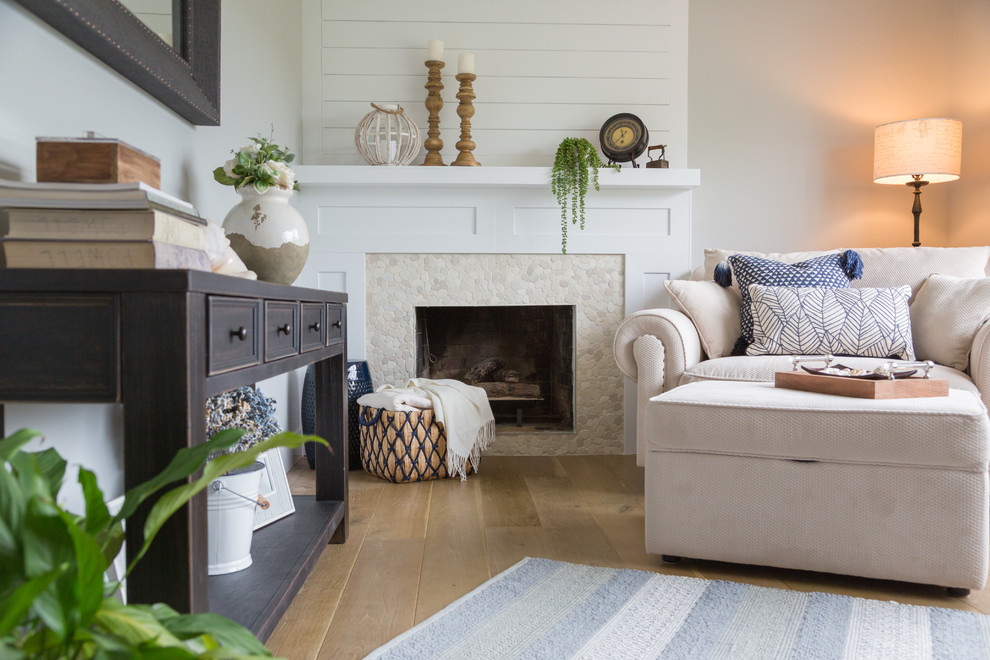 Design ideas for a medium sized modern open plan living room with beige walls, medium hardwood flooring and a standard fireplace.