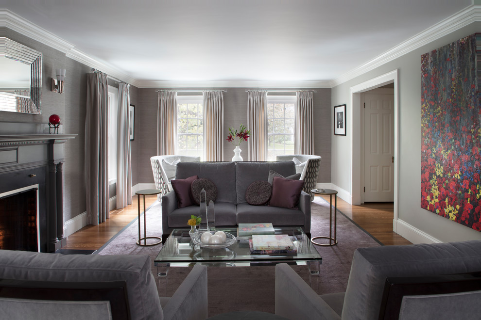 Идея дизайна: большая изолированная гостиная комната в современном стиле с серыми стенами, паркетным полом среднего тона, стандартным камином, фасадом камина из дерева и фиолетовым полом