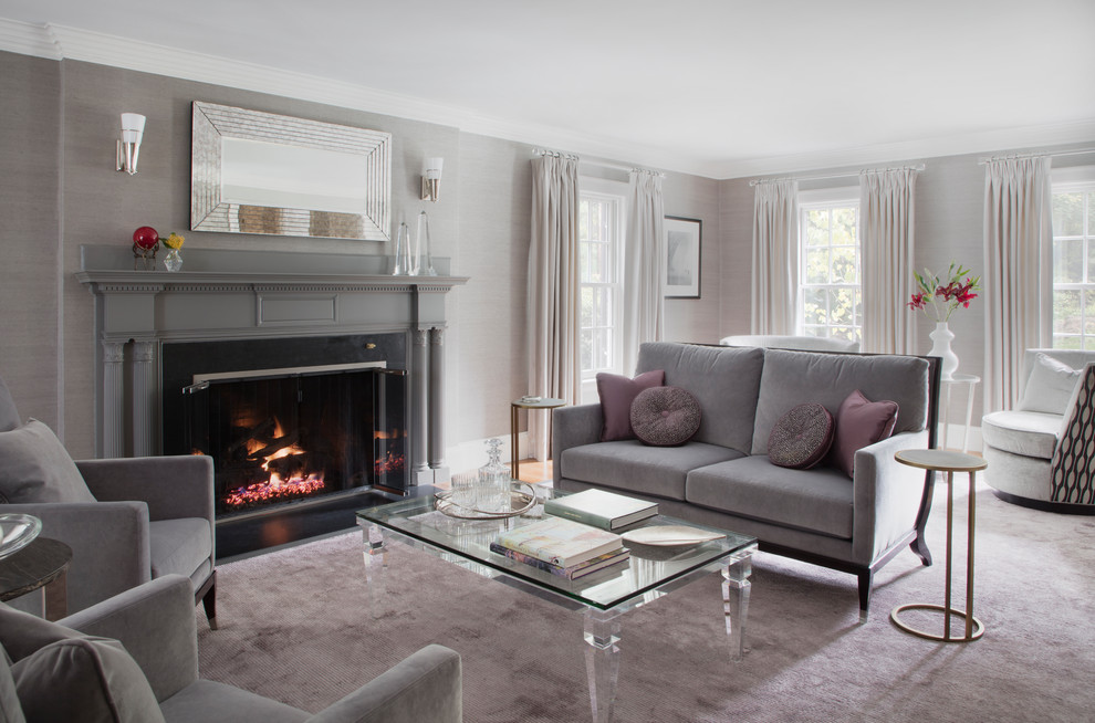 Example of a large transitional enclosed medium tone wood floor and brown floor living room design in Boston with gray walls and a standard fireplace